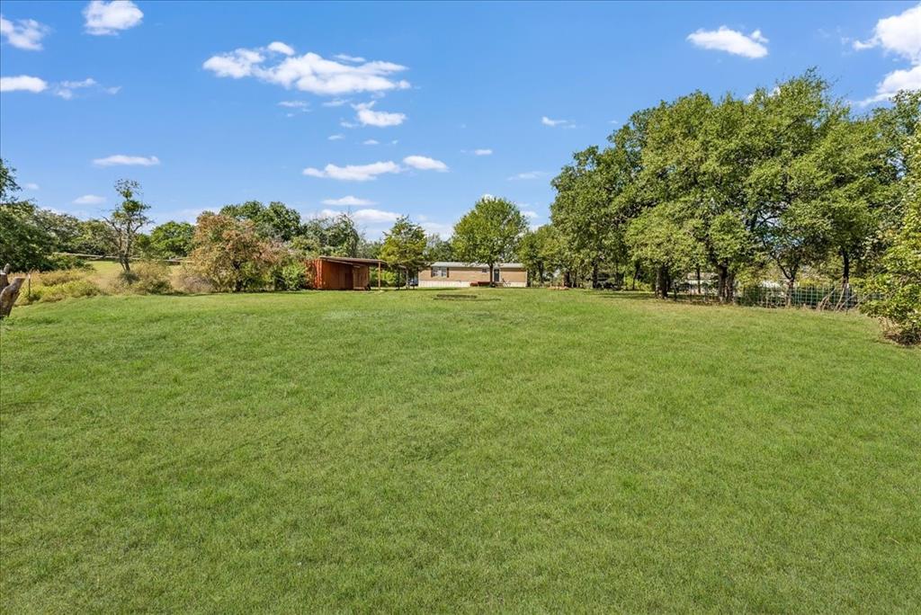 107 Hidden View Court Springtown, TX 76082 - Photo 23 of 24 a view of a big yard with a house