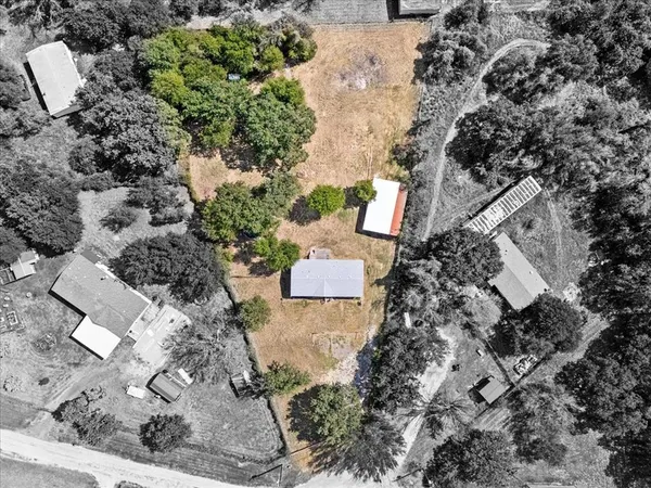 an aerial view of a house with a yard