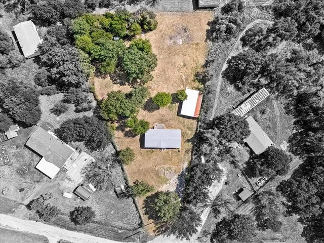 an aerial view of a house with a yard