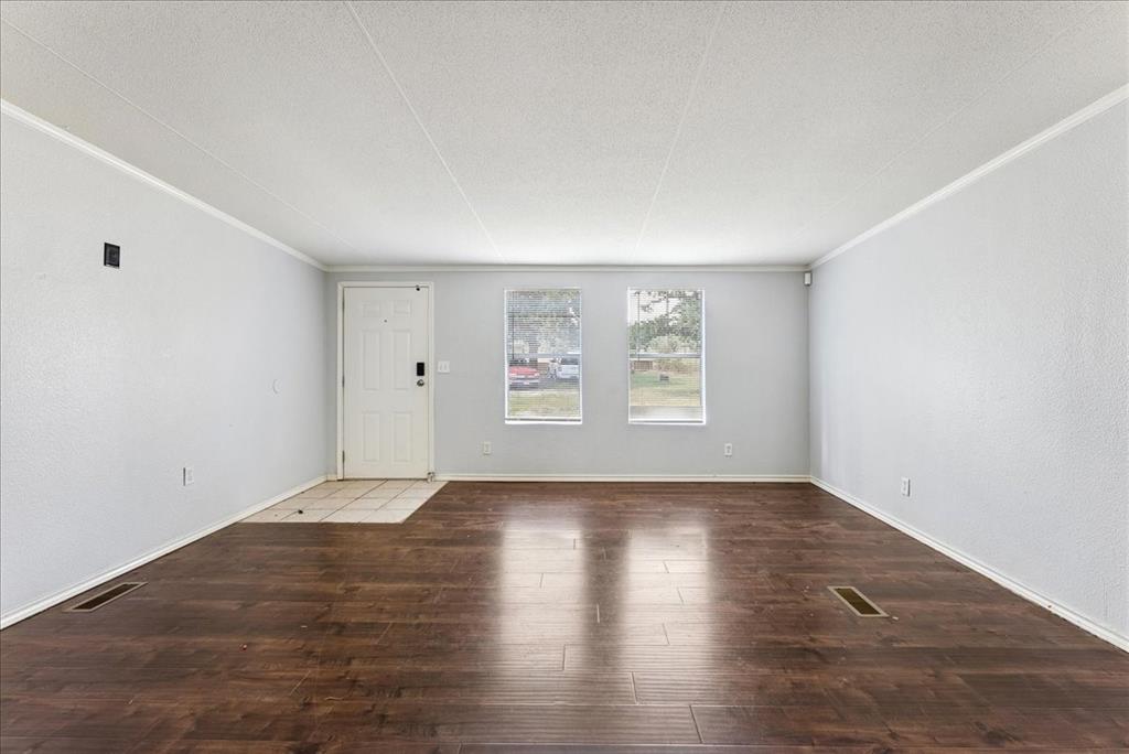 107 Hidden View Court Springtown, TX 76082 - Photo 6 of 24 an empty room with wooden floor and windows