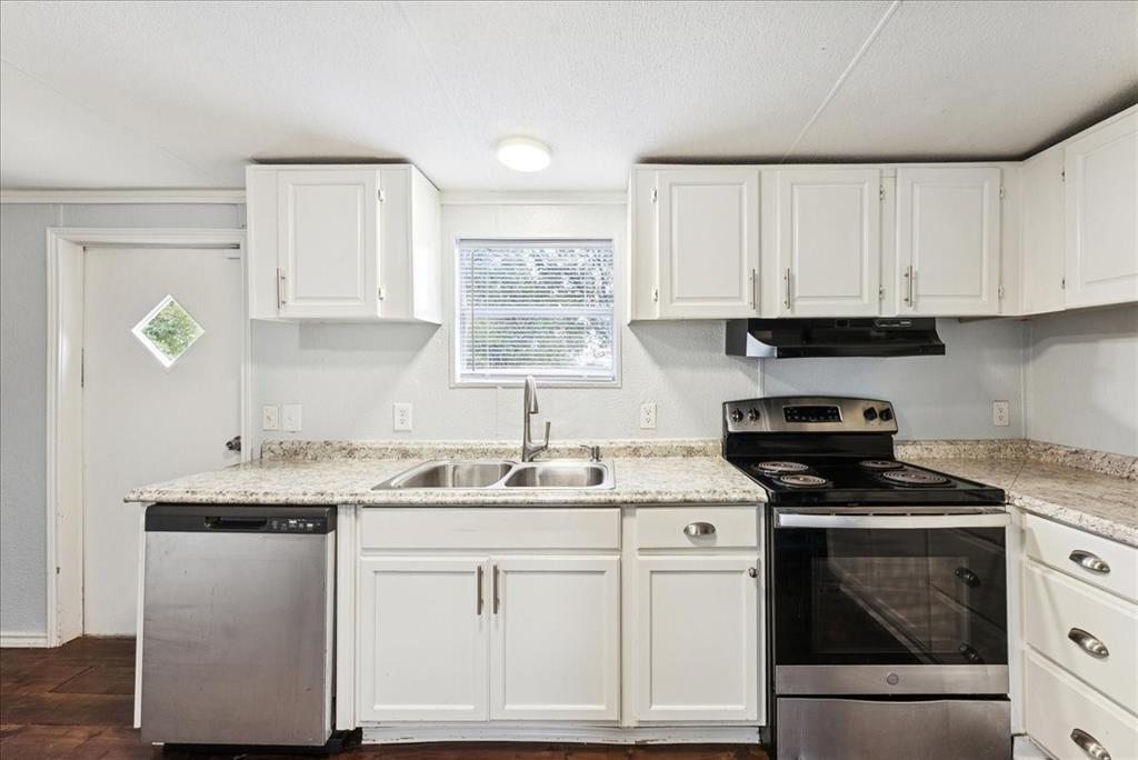 107 Hidden View Court Springtown, TX 76082 - Photo 9 of 24 a kitchen with granite countertop a sink a stove and cabinets