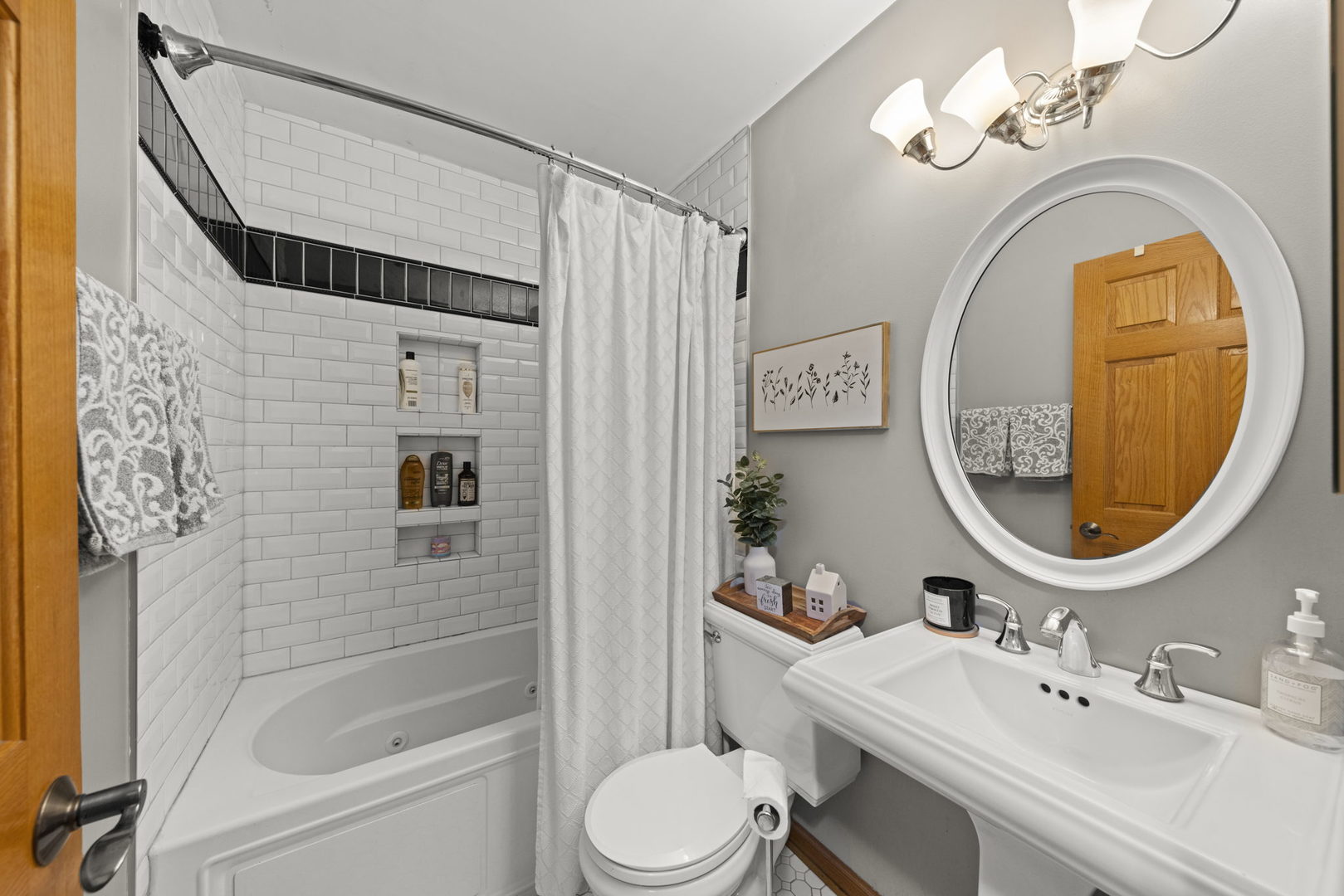 49 Old Post Road Montgomery, IL 60538 - Photo 13 of 31 a bathroom with a sink a mirror a toilet and a shower