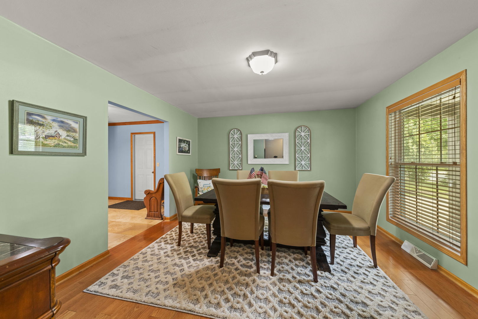 49 Old Post Road Montgomery, IL 60538 - Photo 3 of 31 a dining room with furniture a rug and wooden floor