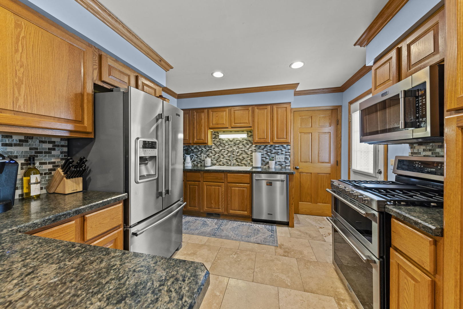 49 Old Post Road Montgomery, IL 60538 - Photo 8 of 31 a kitchen with stainless steel appliances granite countertop a stove a sink and a refrigerator