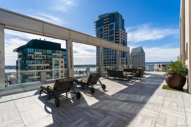a living room with patio furniture and a floor to ceiling window