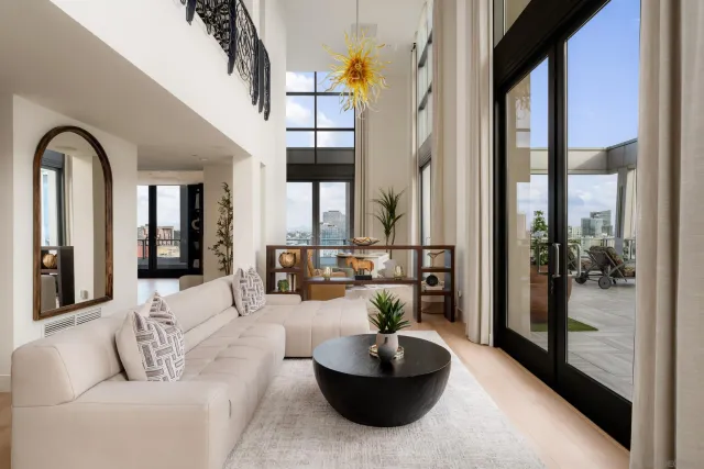 a view of balcony with furniture and floor to ceiling window