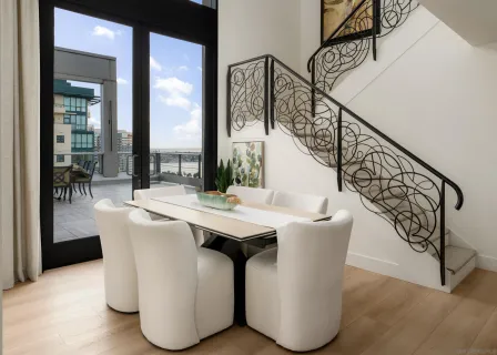 a view of a chairs and table in the balcony