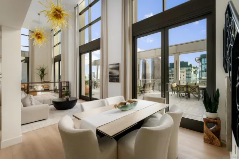 a view of a patio with a dining table and chairs with wooden floor