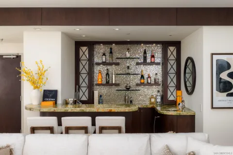 a living room with stainless steel appliances kitchen island granite countertop furniture and a view of kitchen