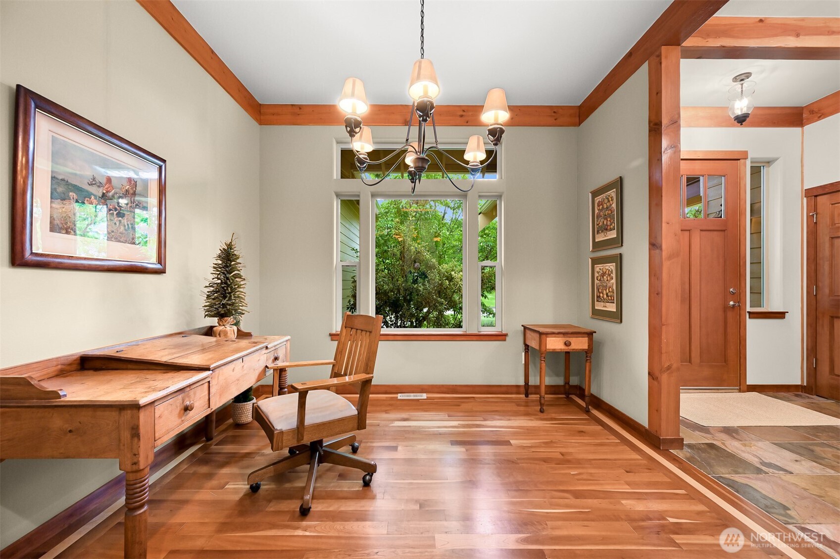 1910 40th Street Bellingham, WA 98229 - Photo 19 of 40 a dining room with wooden floor a chandelier a wooden table and chairs