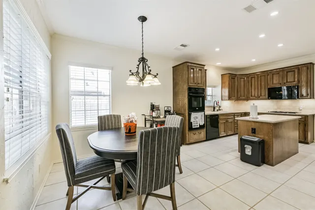 a dining room with furniture a chandelier and wooden floor