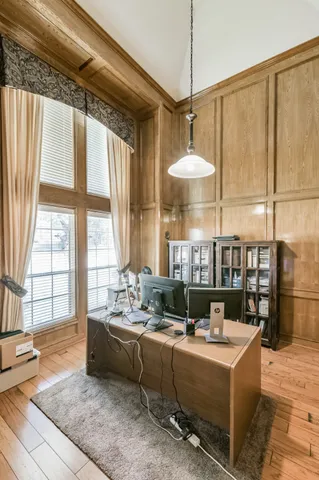 a bedroom with furniture and a mirror