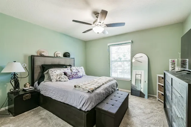 a bedroom with furniture and a flat screen tv