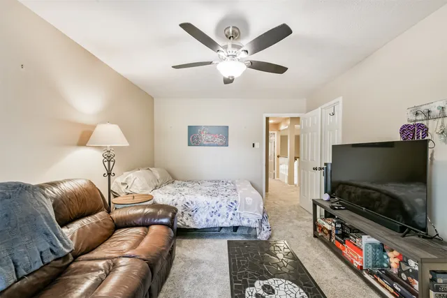 a backyard of a house with table and chairs and couches chair