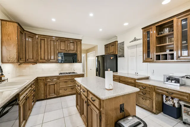 a kitchen that has a lot of cabinets in it and wooden floors