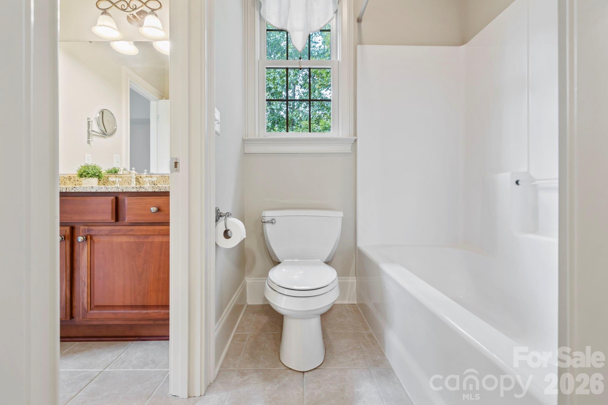 46 Beale Court Fletcher, NC 28732 - Photo 27 of 48 a white toilet sitting next to a bathroom sink