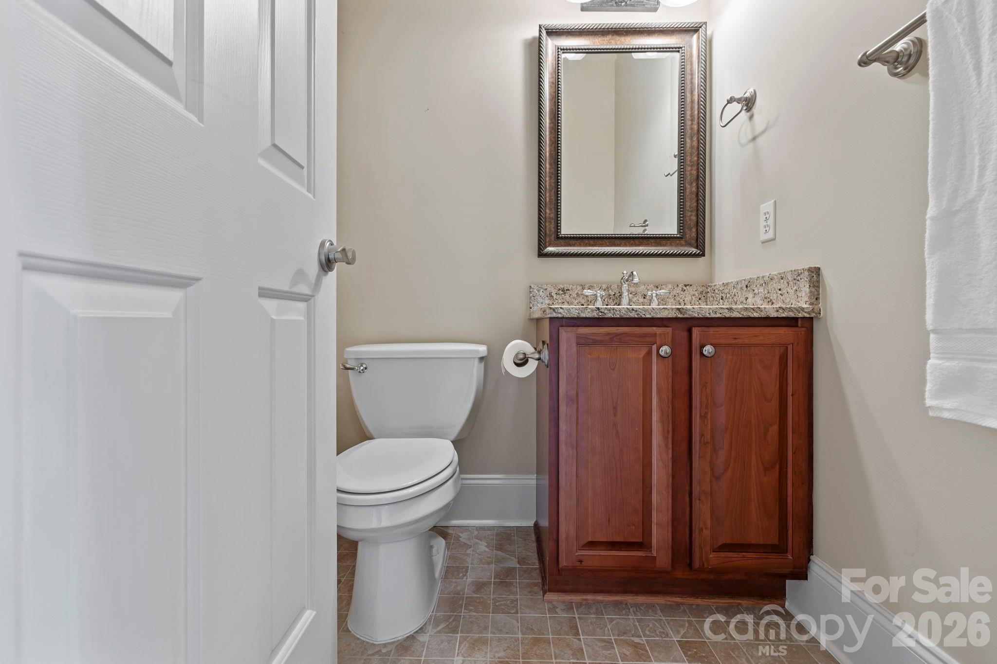46 Beale Court Fletcher, NC 28732 - Photo 31 of 48 a bathroom with a toilet a sink and mirror