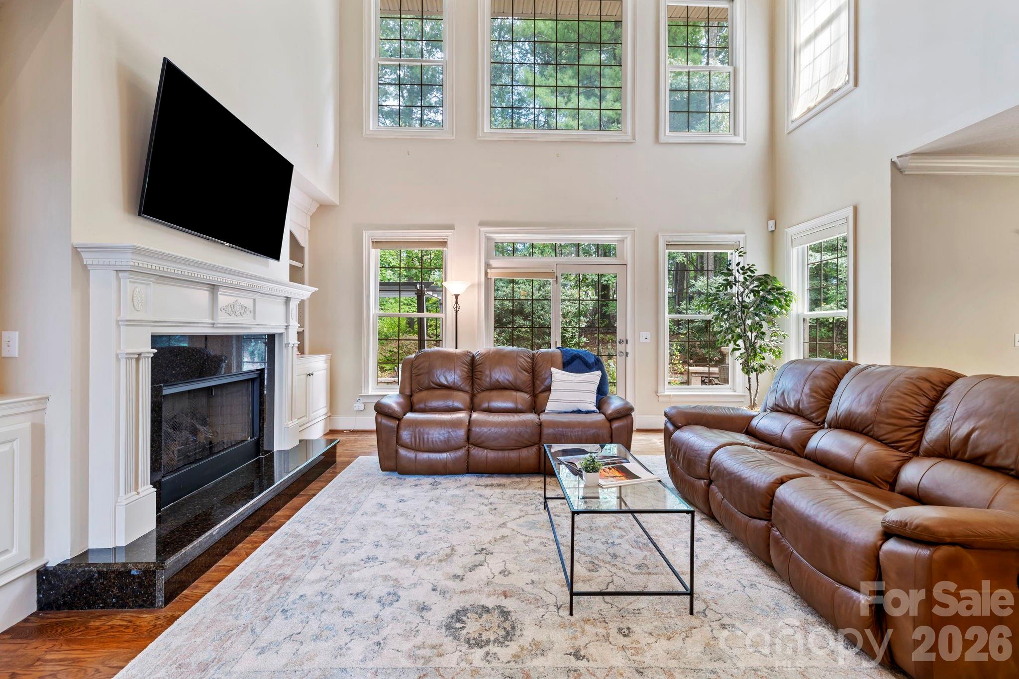 46 Beale Court Fletcher, NC 28732 - Photo 6 of 48 a living room with furniture a flat screen tv and a fireplace