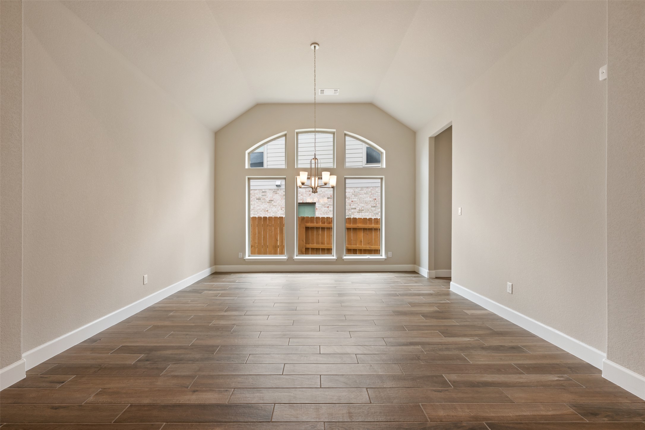 104 Anejo Bluff Georgetown, TX 78628 - Photo 16 of 40 an empty room with wooden floor and windows