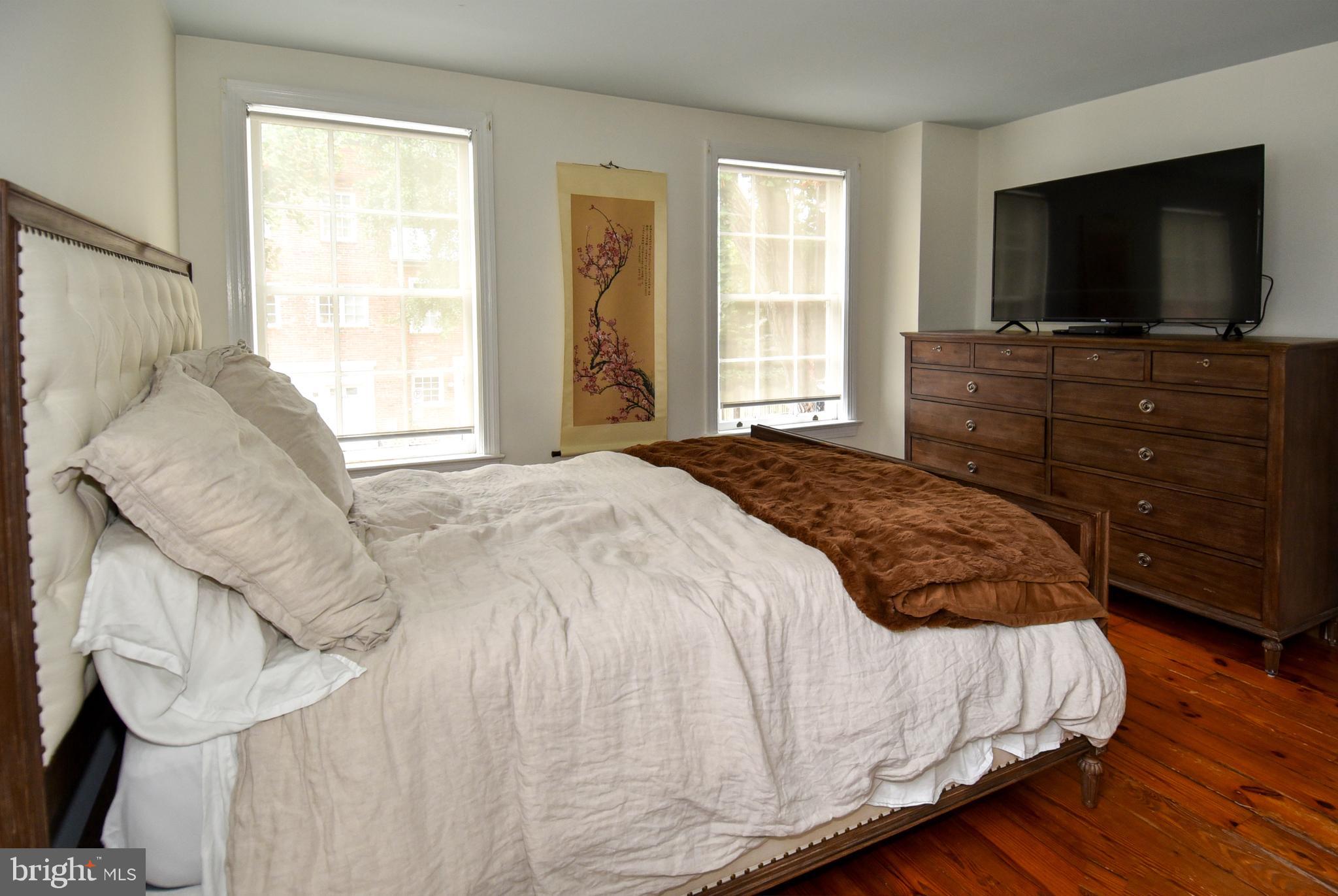 1412 27th Street Northwest Washington, DC 20007 - Photo 17 of 28 a bedroom with a bed and flat screen tv