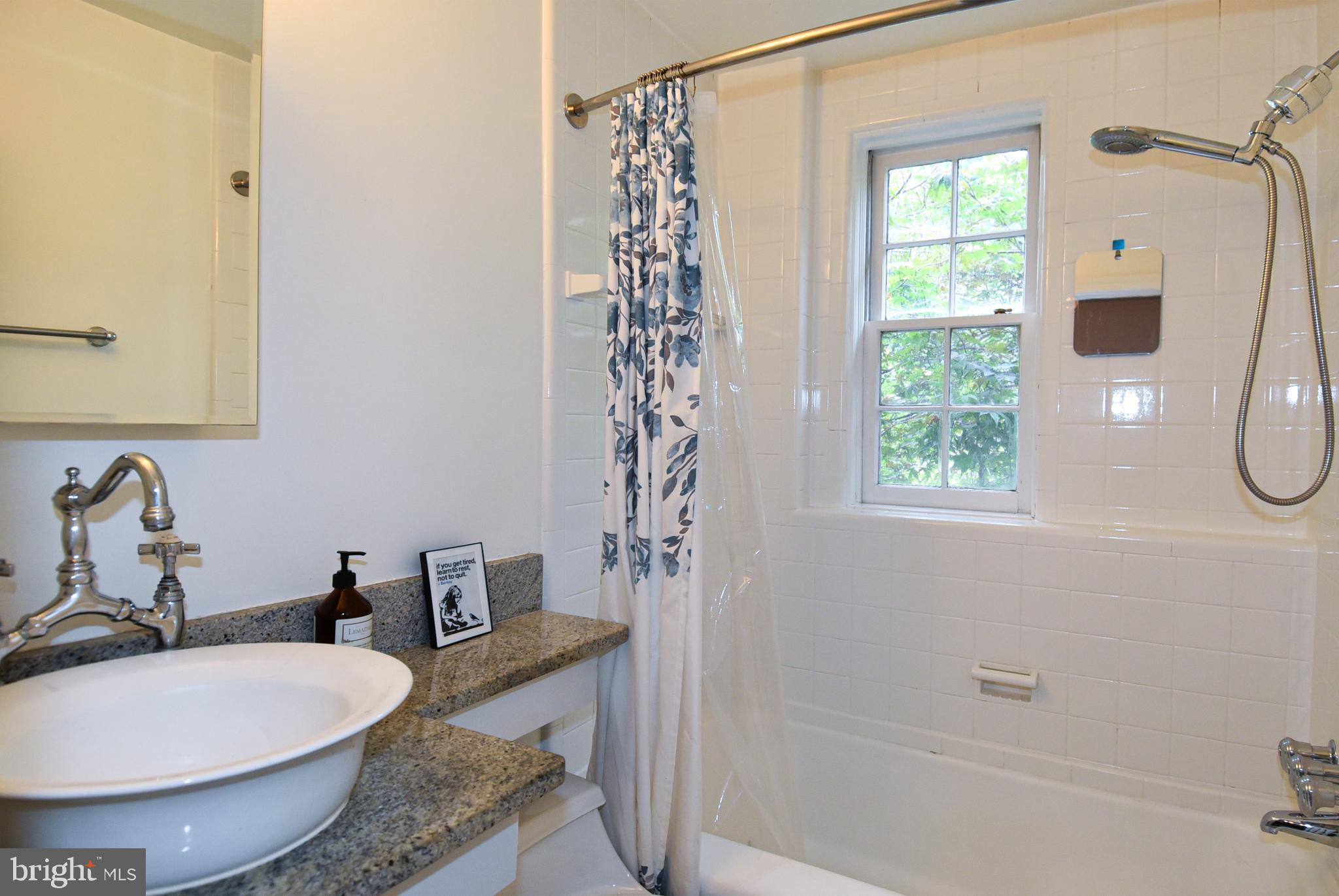 1412 27th Street Northwest Washington, DC 20007 - Photo 18 of 28 a bathroom with a granite countertop sink and a mirror