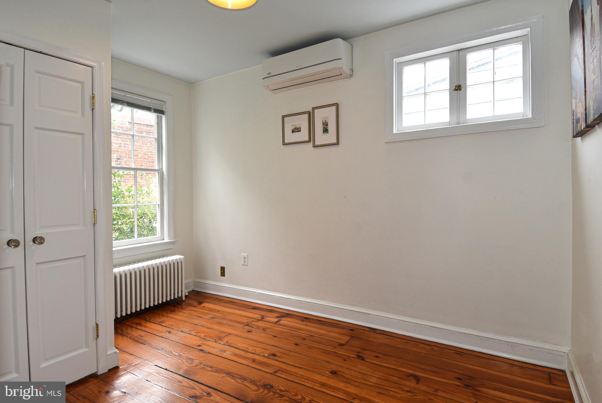 1412 27th Street Northwest Washington, DC 20007 - Photo 19 of 28 an empty room with a window and wooden floor