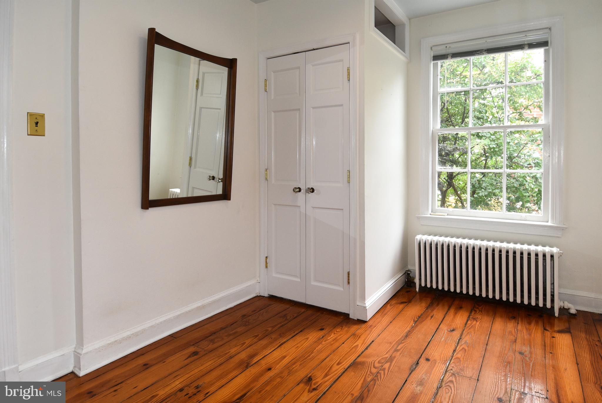 1412 27th Street Northwest Washington, DC 20007 - Photo 20 of 28 a view of an empty room with wooden floor and a window