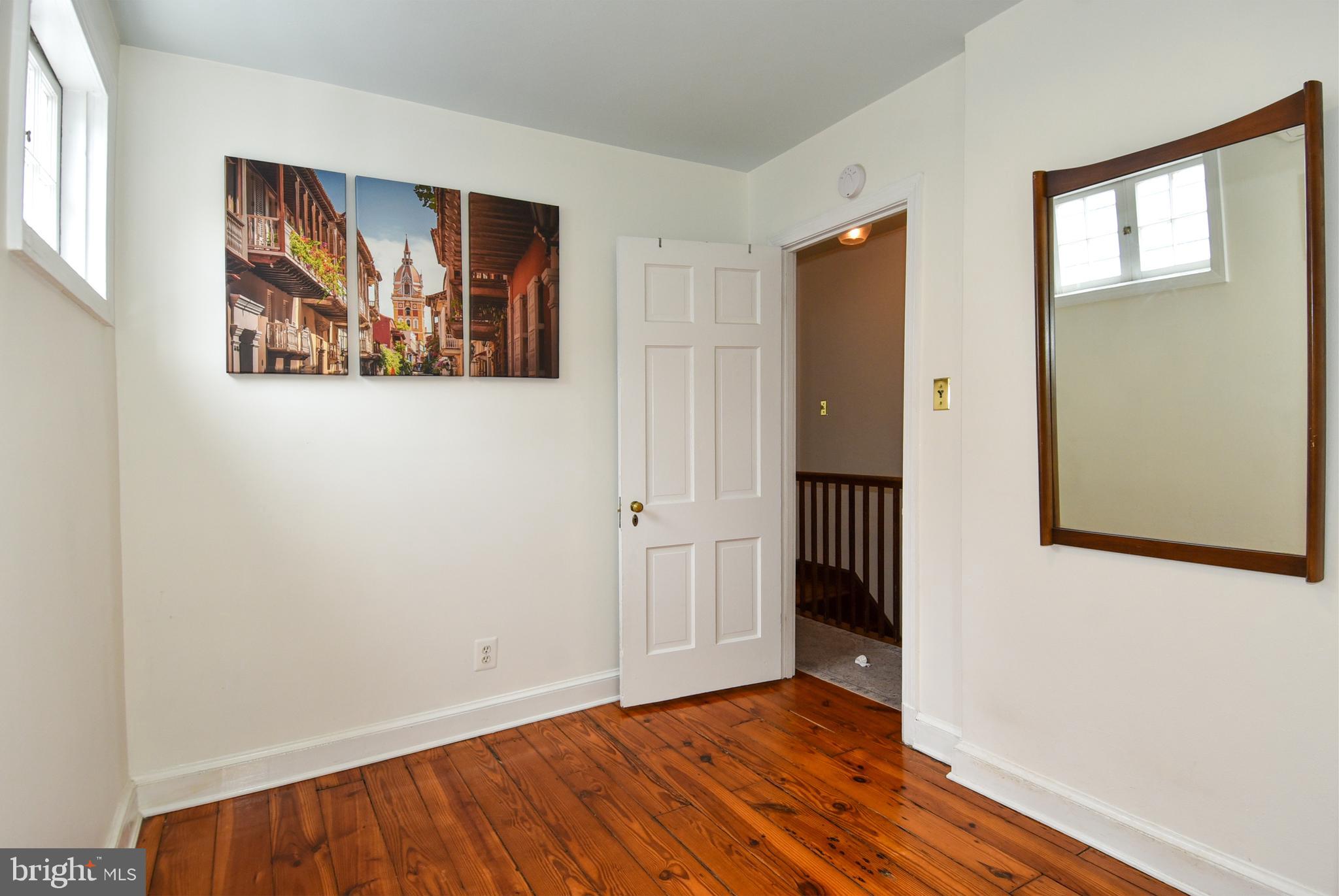 1412 27th Street Northwest Washington, DC 20007 - Photo 21 of 28 an empty room with wooden floor and windows