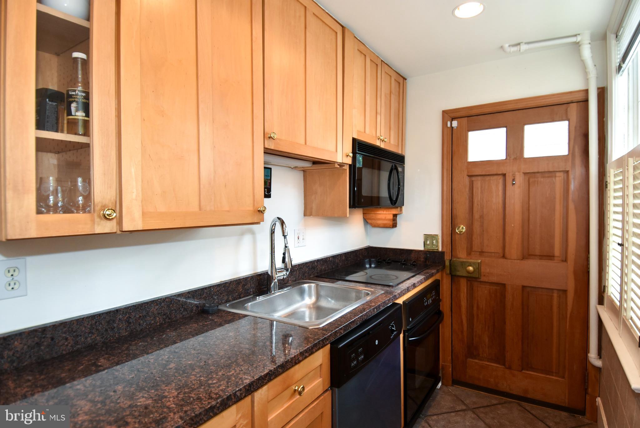 1412 27th Street Northwest Washington, DC 20007 - Photo 3 of 28 a kitchen with a sink stove and cabinets