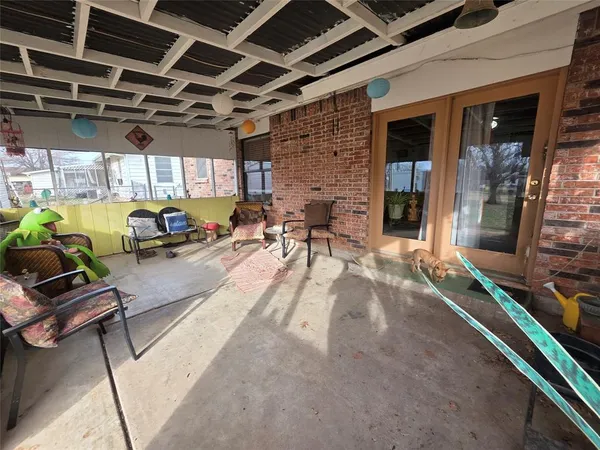 a view of a patio with table and chairs