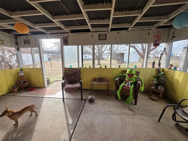 a living room with furniture and a gym machine