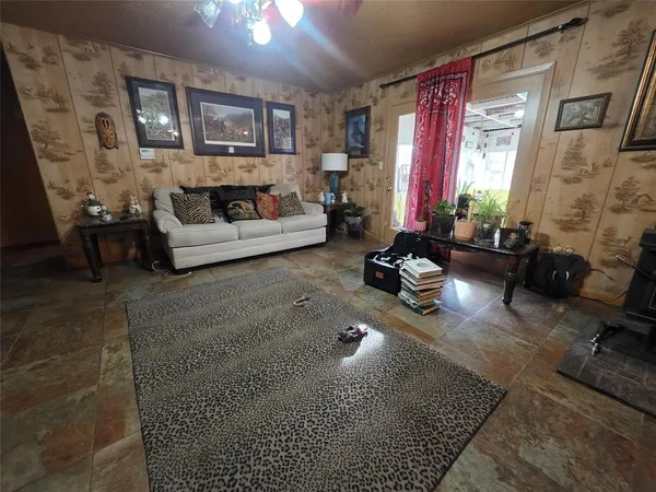 a living room with furniture rug and window