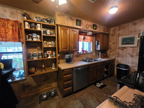 a kitchen with a sink stove and cabinets