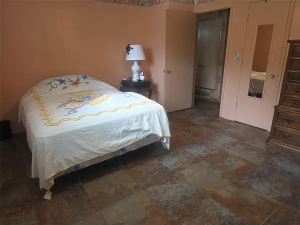 a bedroom with a bed and a mirror