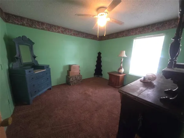 a bedroom with a bed and a television