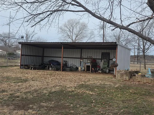a view of a house with yard and sitting area