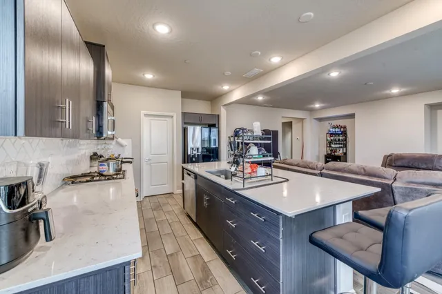 a large kitchen with stainless steel appliances lots of counter space and breakfast area