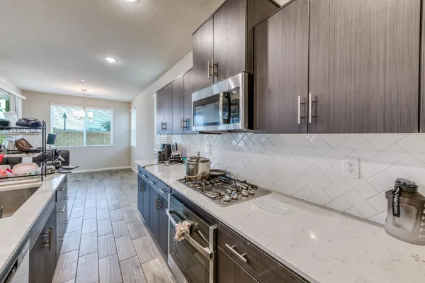 a kitchen with a sink stove and cabinets
