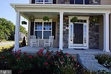 53 Woods Road Chester, MD 21619 - Photo 2 of 17 front view of the house and a porch