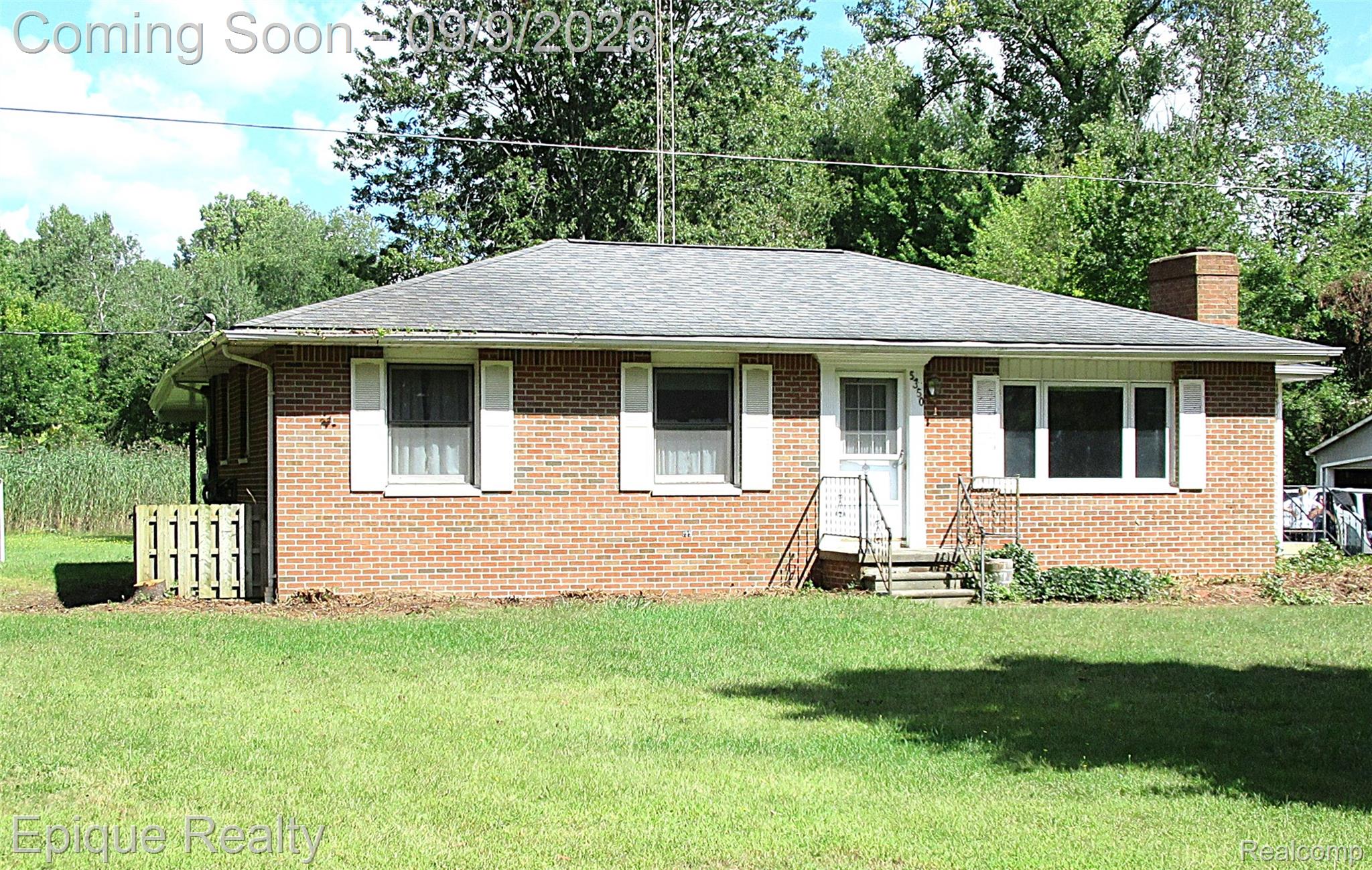 5350 Davis Road St. Clair, MI 48079 - Photo 2 of 21 Brick exterior with white window shutters and a gabled roof