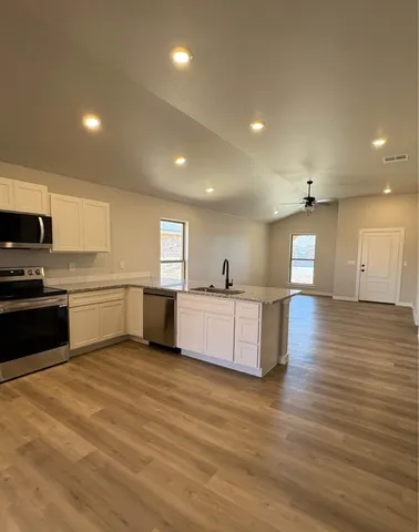 a large kitchen with a center island and a counter top space