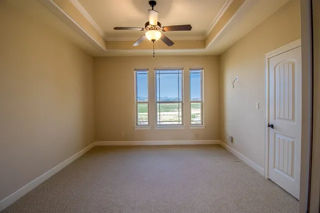 a view of room with a ceiling fan and a window
