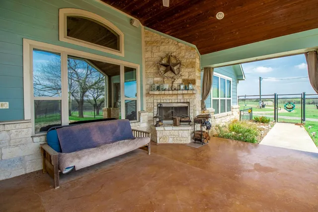 a outdoor living space with furniture and a fireplace