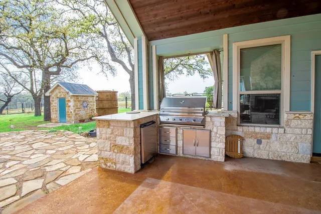 a view of house with backyard and furniture