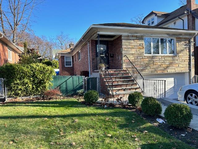 33-53 164th Street, Unit 1 Queens, NY 11358 - Photo 1 of 1 a front view of a house with a yard