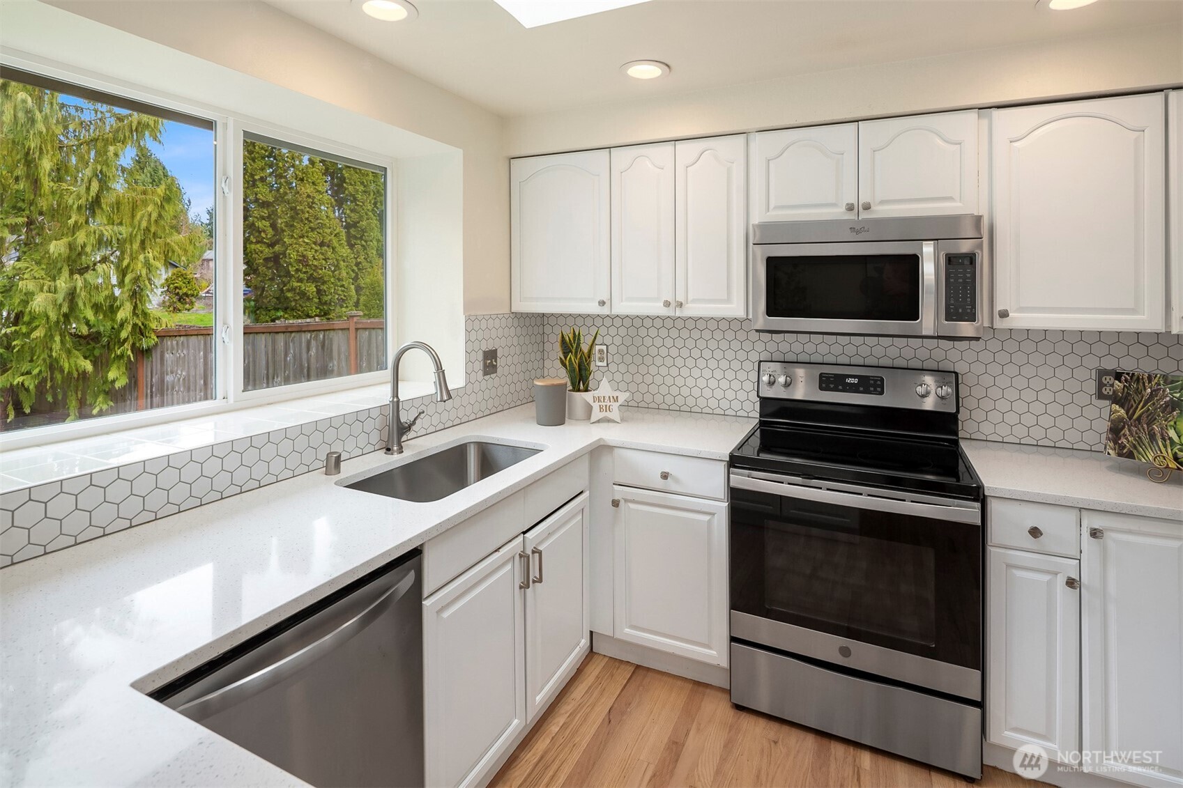 2413 166th Place Southeast Bothell, WA 98012 - Photo 11 of 32 a kitchen with a sink stove and microwave