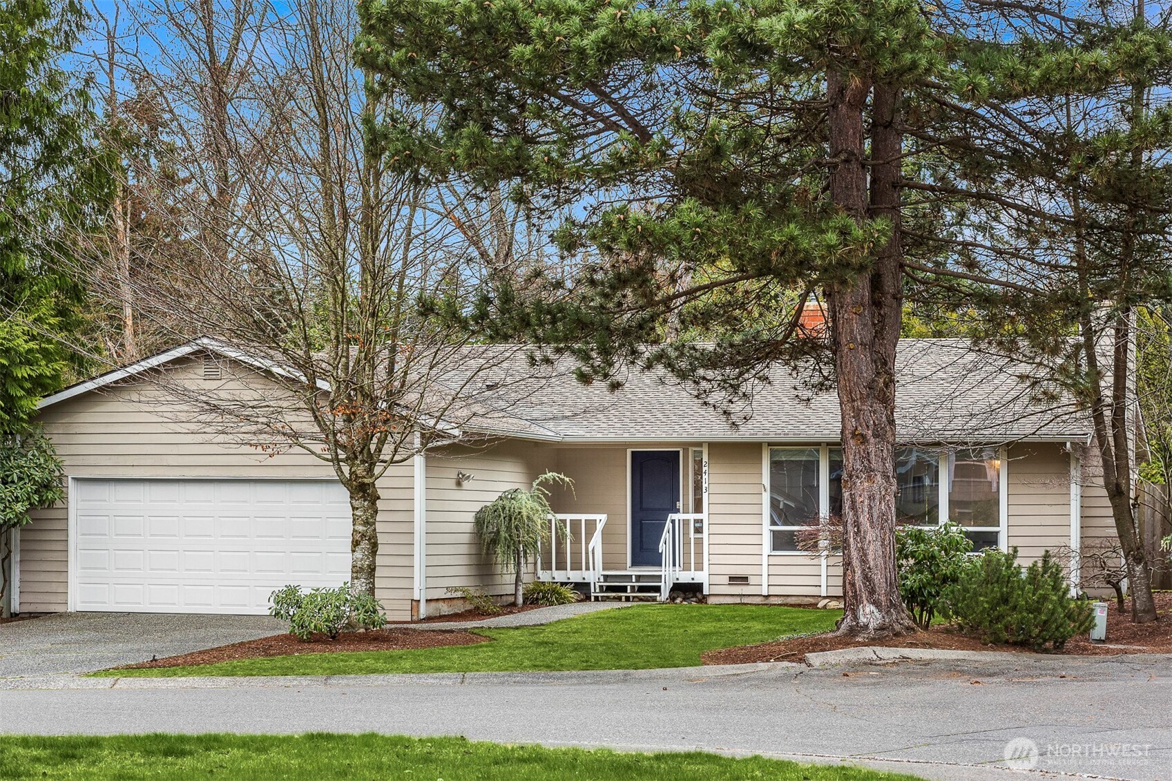 2413 166th Place Southeast Bothell, WA 98012 - Photo 31 of 32 a front view of a house with a yard and garage