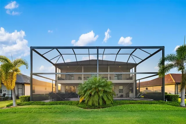 a spacious bedroom with a bed and a chandelier