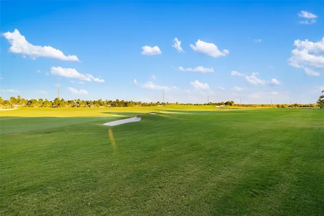 a large white bathroom with a double vanity sink a window and a mirror