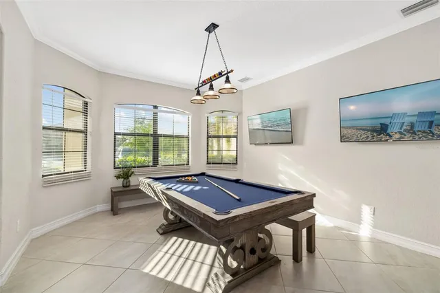 a view of a dining room with furniture floor to ceiling window and potted plants